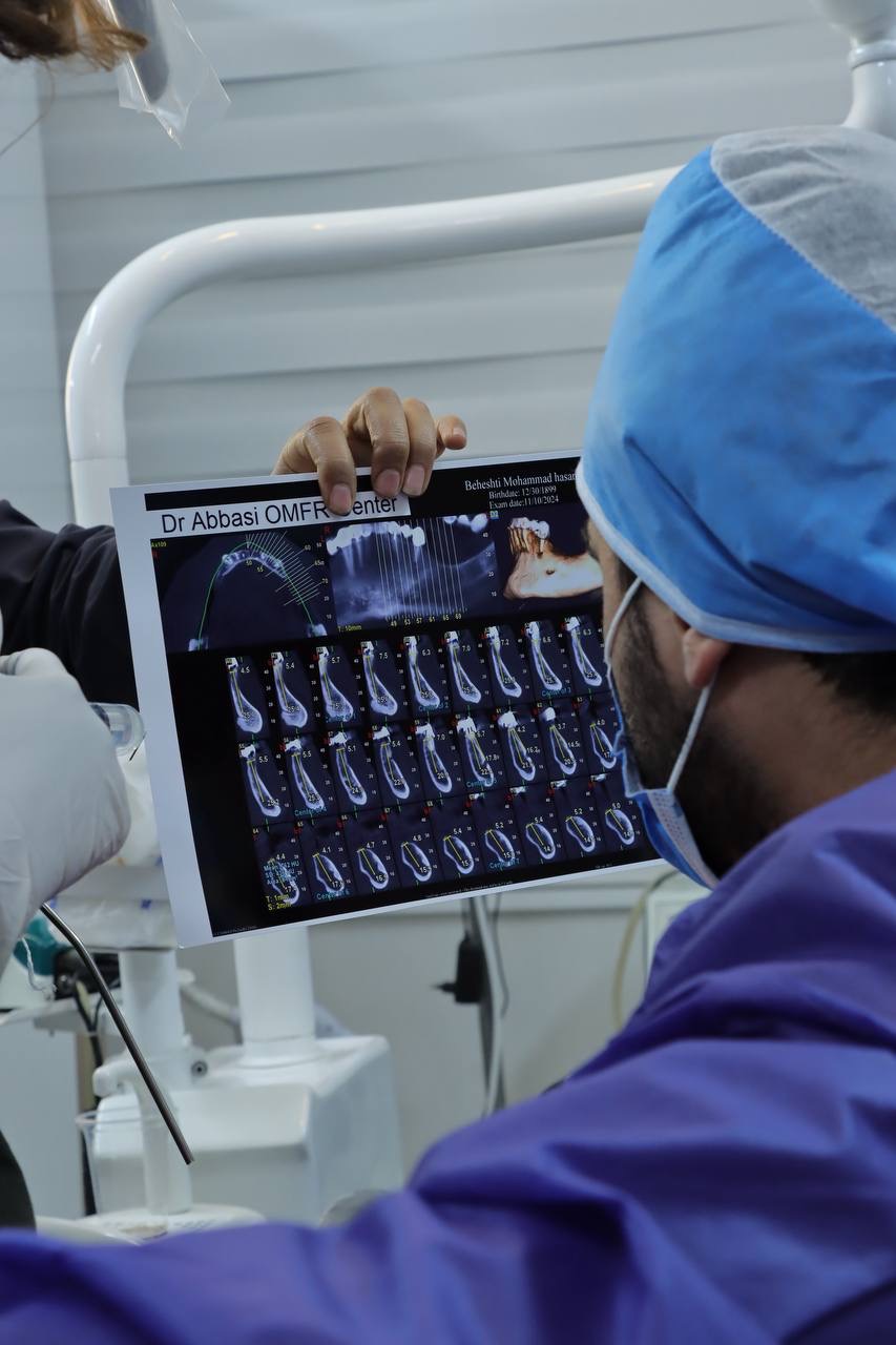 دکتر مشایخی در حال تحلیل دقیق رادیوگرافی دیجیتال دندان بیمار